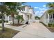 Charming two-story home featuring a well-manicured lawn, and a private driveway leading to a detached garage at 11227 Moultrie Pl, Tampa, FL 33625