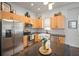 Well-lit kitchen features stainless steel appliances and light wood cabinets at 11227 Moultrie Pl, Tampa, FL 33625