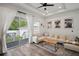 Bright living room features an open layout with a large sectional couch and patio access at 11227 Moultrie Pl, Tampa, FL 33625