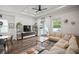 Open-concept living room with hardwood floors, a large sectional, and natural light at 11227 Moultrie Pl, Tampa, FL 33625