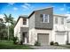 New construction home featuring modern architecture, neutral colors, a garage, and lush landscaping at 1144 Creek Valley Ct, Brandon, FL 33511