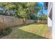 Spacious backyard showcasing a well-maintained lawn and wooden fence, offering ample outdoor space at 116 W Stanley St, Tampa, FL 33604