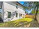 Spacious backyard with lush lawn, exterior home view, and shaded seating area at 116 W Stanley St, Tampa, FL 33604