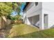 Spacious backyard featuring a covered patio and ample green space at 116 W Stanley St, Tampa, FL 33604