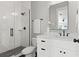 Modern bathroom features black fixtures, a tiled shower, and a white vanity at 116 W Stanley St, Tampa, FL 33604