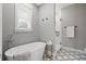 Stylish bathroom featuring a freestanding tub, glass shower, and patterned tile flooring at 116 W Stanley St, Tampa, FL 33604