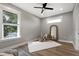 Bedroom with light gray walls, hardwood floors, a large mirror and a large window at 116 W Stanley St, Tampa, FL 33604