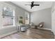 Cozy bedroom with hardwood floors, large windows, and a ceiling fan at 116 W Stanley St, Tampa, FL 33604