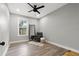 Bedroom with hardwood floors, large window and gray accent chair at 116 W Stanley St, Tampa, FL 33604
