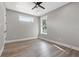 Bright bedroom featuring hardwood floors, two windows, and neutral paint at 116 W Stanley St, Tampa, FL 33604