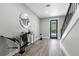 Entryway featuring hardwood floors, staircase with black iron railing, and a decorative mirror at 116 W Stanley St, Tampa, FL 33604