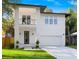 Modern two-story home with a front balcony, a two-car garage and a well-manicured lawn at 116 W Stanley St, Tampa, FL 33604