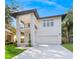 Stunning modern two story home featuring a balcony, a two car garage and lush landscaping at 116 W Stanley St, Tampa, FL 33604