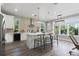Modern kitchen featuring a large island, stainless steel appliances, and hardwood floors at 116 W Stanley St, Tampa, FL 33604