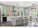 Bright kitchen boasts a large island with seating, stainless steel appliances, and modern pendant lighting at 116 W Stanley St, Tampa, FL 33604