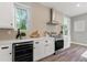 Bright kitchen with white cabinets, stainless steel appliances, and wine fridge at 116 W Stanley St, Tampa, FL 33604