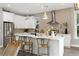 Bright kitchen with an island, stainless steel appliances, and modern pendant lights at 116 W Stanley St, Tampa, FL 33604