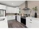 Bright kitchen with white cabinets, stainless steel appliances, and wine fridge at 116 W Stanley St, Tampa, FL 33604