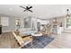 Open-concept living room featuring hardwood floors, modern decor, and seamless flow to the kitchen at 116 W Stanley St, Tampa, FL 33604