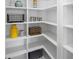 Organized pantry with white shelving, providing ample storage space at 116 W Stanley St, Tampa, FL 33604