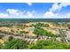 Aerial view showcases the property's location amidst a lush community, golf course, and serene lake at 1177 Emerald Hill Way, Valrico, FL 33594