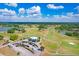 Stunning aerial view of the golf course with a clubhouse and parking under a beautiful blue sky at 1177 Emerald Hill Way, Valrico, FL 33594