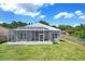 Spacious backyard featuring an enclosed lanai, offering an ideal outdoor living space at 1177 Emerald Hill Way, Valrico, FL 33594