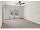 Spacious bedroom with neutral carpet, ceiling fan, and natural light from the large window at 1177 Emerald Hill Way, Valrico, FL 33594