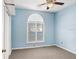 Bedroom features a large window, ceiling fan, closet, and blue painted walls at 1177 Emerald Hill Way, Valrico, FL 33594