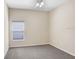 Cozy bedroom with a ceiling fan and a window providing natural light; neutral walls and carpet at 1177 Emerald Hill Way, Valrico, FL 33594
