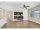 Open layout showcasing living and kitchen space with stainless steel appliances and bar seating at 1177 Emerald Hill Way, Valrico, FL 33594