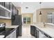 Modern kitchen features stainless appliances, granite counters, and a view to the outdoors at 1177 Emerald Hill Way, Valrico, FL 33594