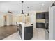 Open kitchen featuring dark cabinets, white countertops, and modern pendant lighting at 1177 Emerald Hill Way, Valrico, FL 33594