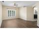 Bright living room showcasing laminate floors, neutral walls, and a view into the adjacent dining area at 1177 Emerald Hill Way, Valrico, FL 33594