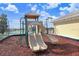 Community playground that is fenced in with a slide and surrounding rubber mulch at 1177 Emerald Hill Way, Valrico, FL 33594