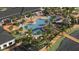 Aerial view of a resort-style pool, lounge chairs, palm trees and a BBQ area at 12054 Violet Jasper Dr, Parrish, FL 34219