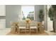 Bright dining room with a wooden table, stylish chairs and a large window at 12054 Violet Jasper Dr, Parrish, FL 34219