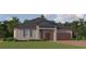 Charming single-story home with a well-manicured lawn, brick driveway and two-car garage at 12054 Violet Jasper Dr, Parrish, FL 34219