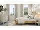 Inviting bedroom with large windows, wood flooring, and modern furniture at 12054 Violet Jasper Dr, Parrish, FL 34219