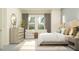 Inviting main bedroom with large windows, neutral tones, and comfortable seating area at 12054 Violet Jasper Dr, Parrish, FL 34219