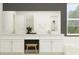 Bright bathroom featuring dual sinks, white cabinets, a makeup vanity and a large mirror for a clean, modern aesthetic at 12058 Violet Jasper Dr, Parrish, FL 34219