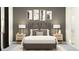 Inviting bedroom showcases contemporary decor, soft lighting and a comfortable upholstered headboard at 12058 Violet Jasper Dr, Parrish, FL 34219