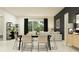 Bright dining room open to living space, featuring stylish decor and abundant natural light at 12058 Violet Jasper Dr, Parrish, FL 34219