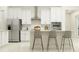 Bright kitchen boasts white cabinetry, stainless steel appliances, and a stylish island with seating at 12058 Violet Jasper Dr, Parrish, FL 34219