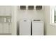 Practical laundry area with a washer, dryer, shelving, cabinets, and a window at 12058 Violet Jasper Dr, Parrish, FL 34219