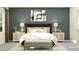 Serene bedroom with a large bed, nightstands, decorative lamps, and stylish wall art at 12062 Violet Jasper Dr, Parrish, FL 34219