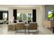 Well-lit living room with large windows, comfortable seating, stylish decor, and an inviting atmosphere at 12062 Violet Jasper Dr, Parrish, FL 34219