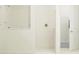 Bright shower features modern fixtures and white tile with glass doors at 12062 Violet Jasper Dr, Parrish, FL 34219