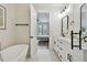 Bright bathroom featuring white vanity, a freestanding tub, and a view into the bedroom, creating a spa-like atmosphere at 121 E Warren Ave # 1, Tampa, FL 33602
