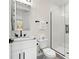 Modern bathroom featuring a glass-enclosed shower, tiled floors, and white vanity at 121 E Warren Ave # 1, Tampa, FL 33602